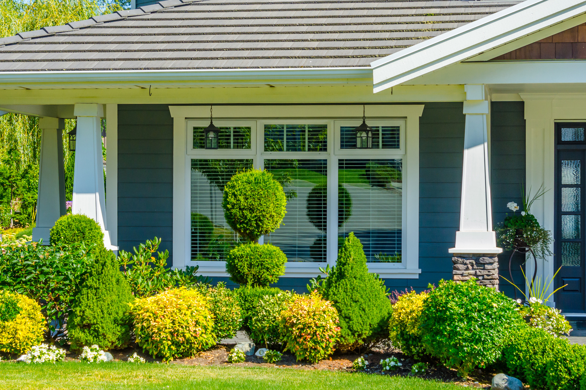 Attractive front garden design with plants and bushes trimmed into shape
