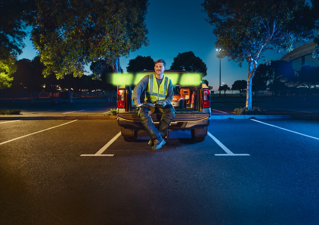 The ALLPRO STIHL AP 300.0 P in the hands of a professional, sitting on the back of a vehicle.