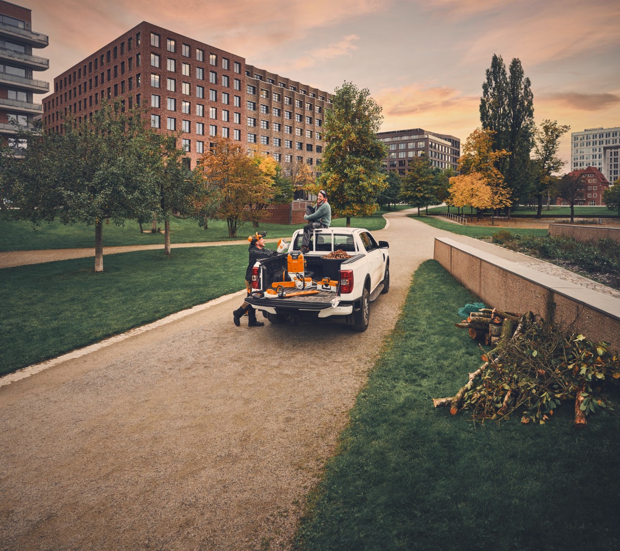 A gardening and landscaping team on a pickup truck after the work is done