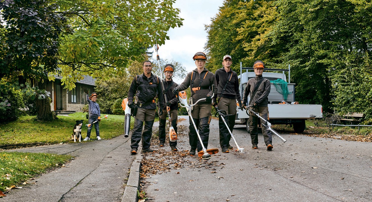 Five people on a street wearing protective equipment and with STIHL battery tools 