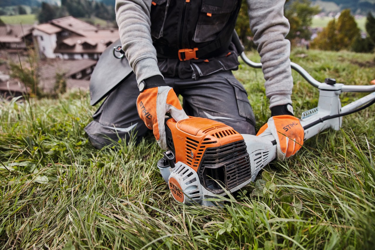 A STIHL FS 311 petrol clearing saw being started