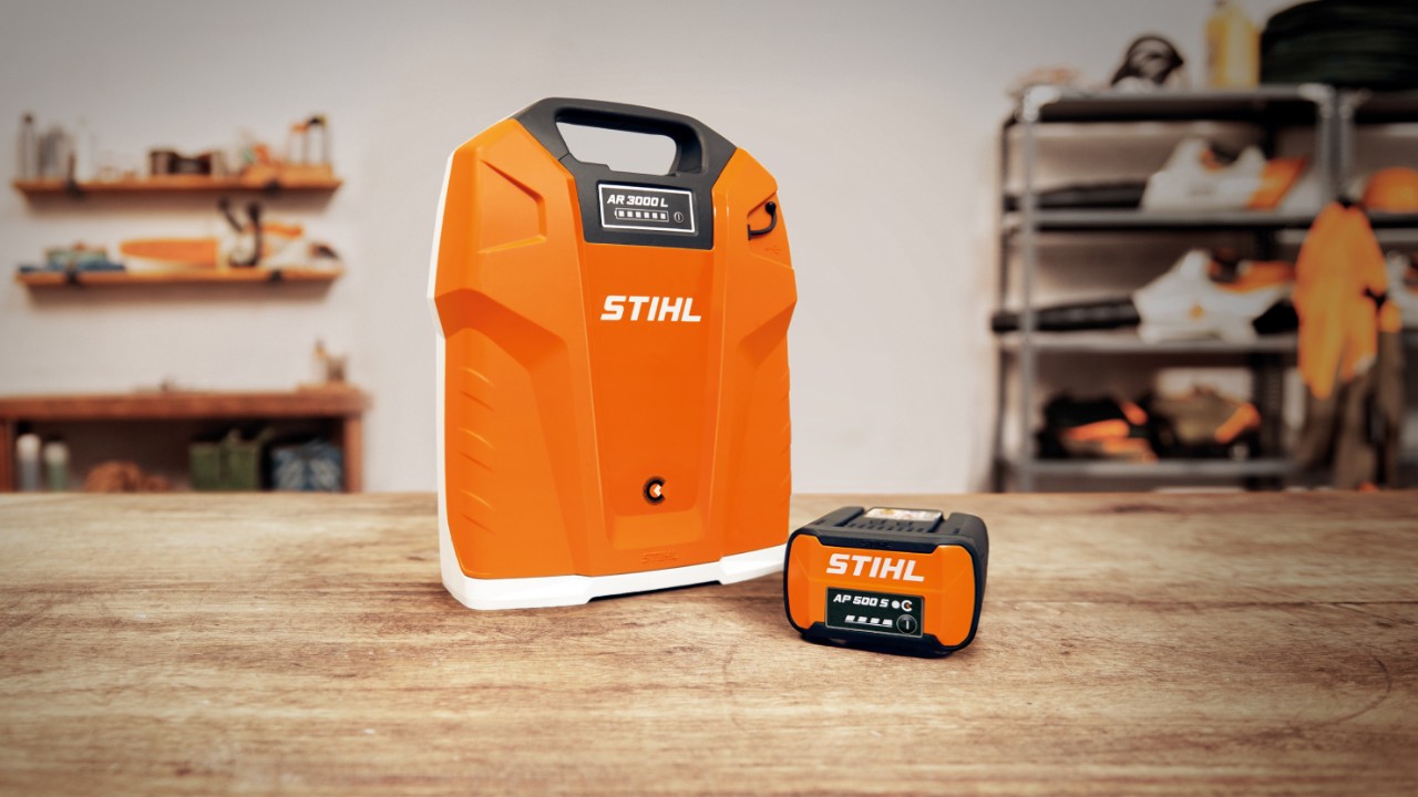 Workshop with a STIHL AR 3000 L backpack battery and a STIHL AP 500 S battery on a wooden table  