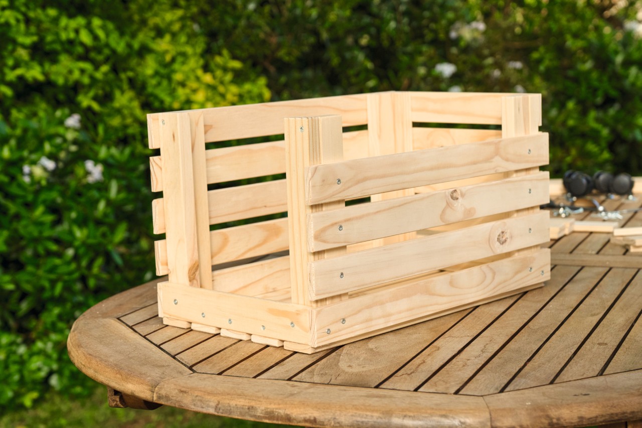 The wooden strips are attached to all sides of the wooden planter
