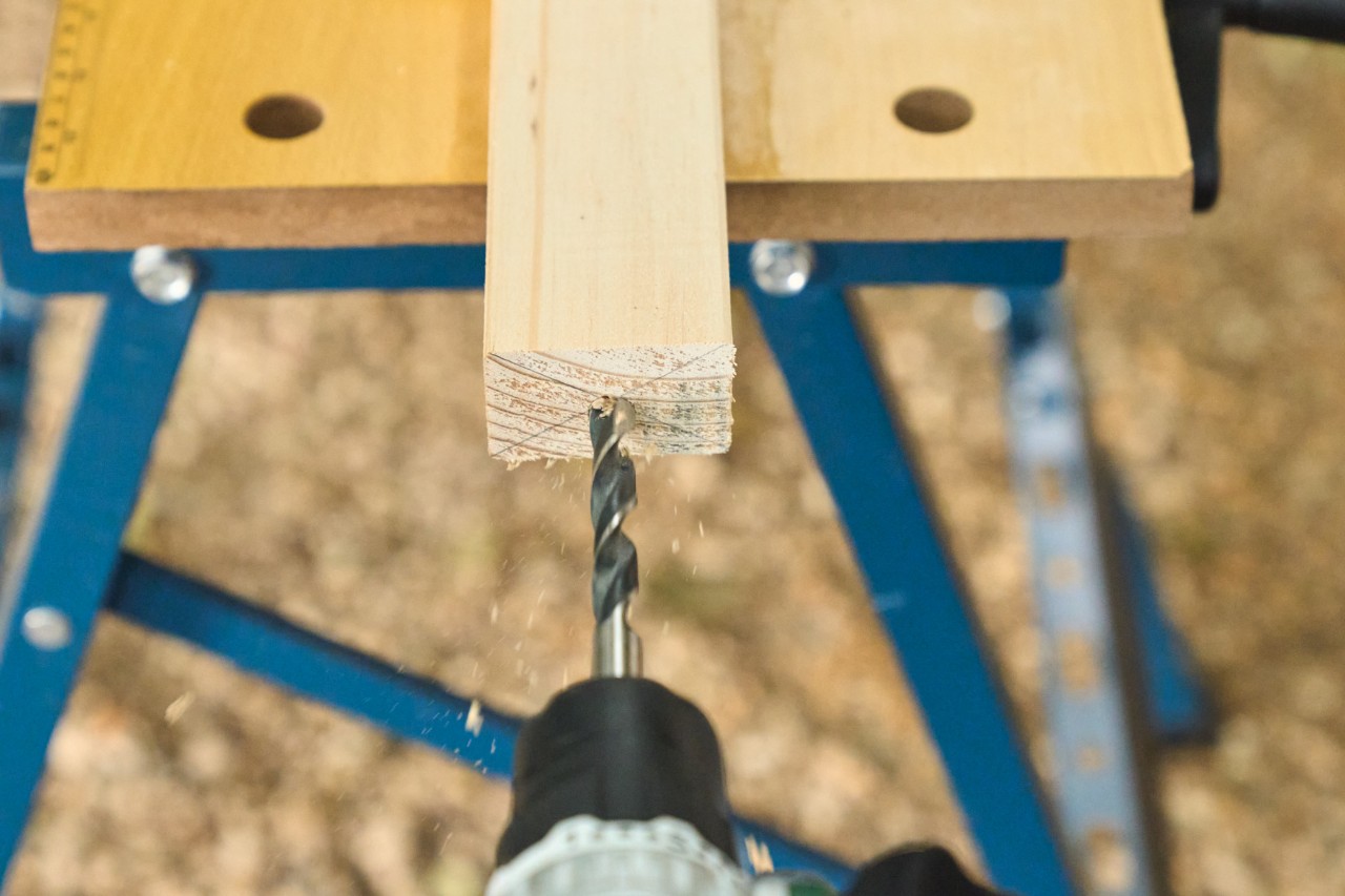 A hole is drilled in the floor strut for the wooden dowel