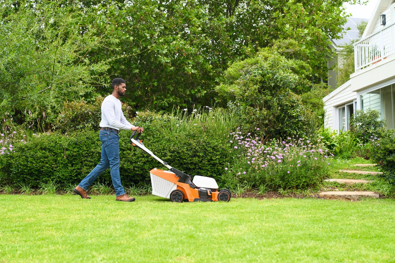 A man mowing the lawn with a STIHL RMA 448 V lawn mower