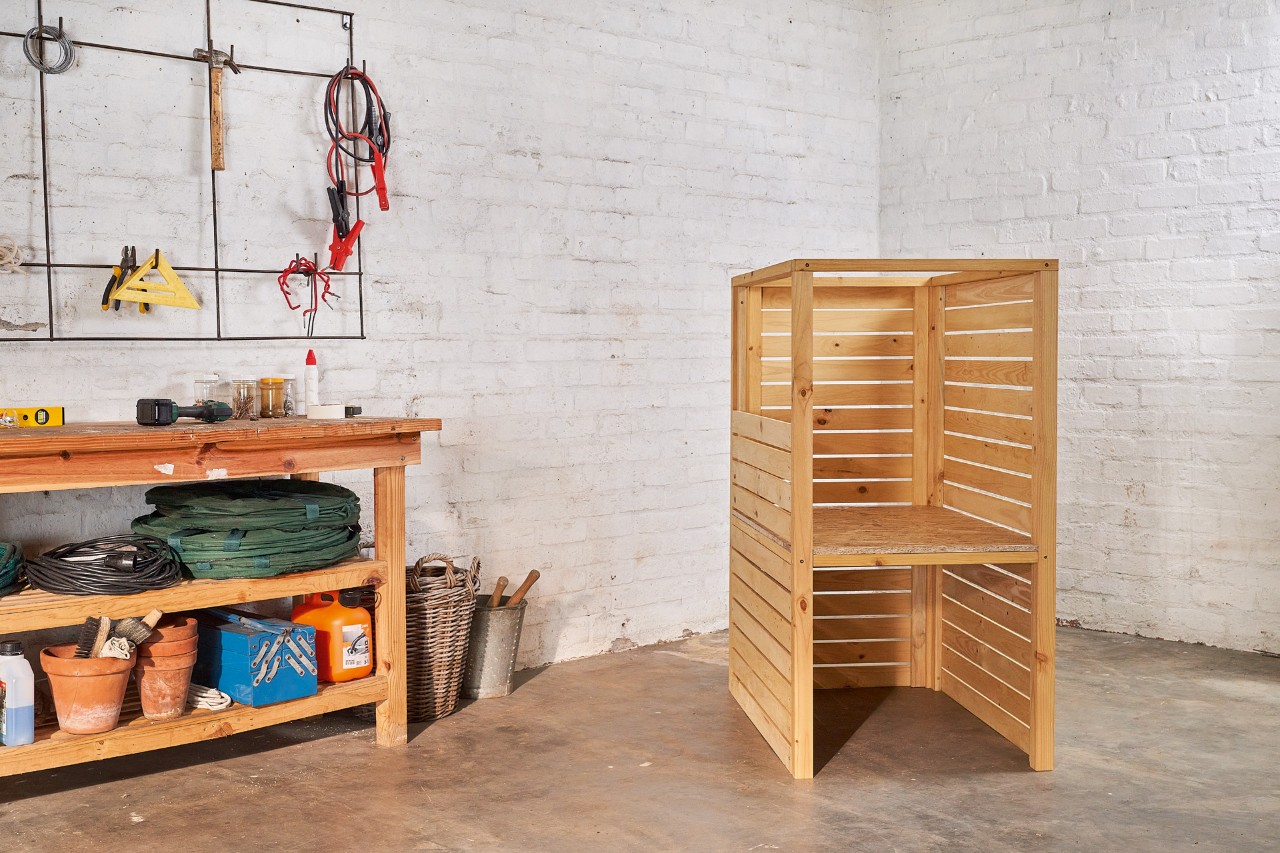 The base frame of a DIY lawn mower storage box in a garage