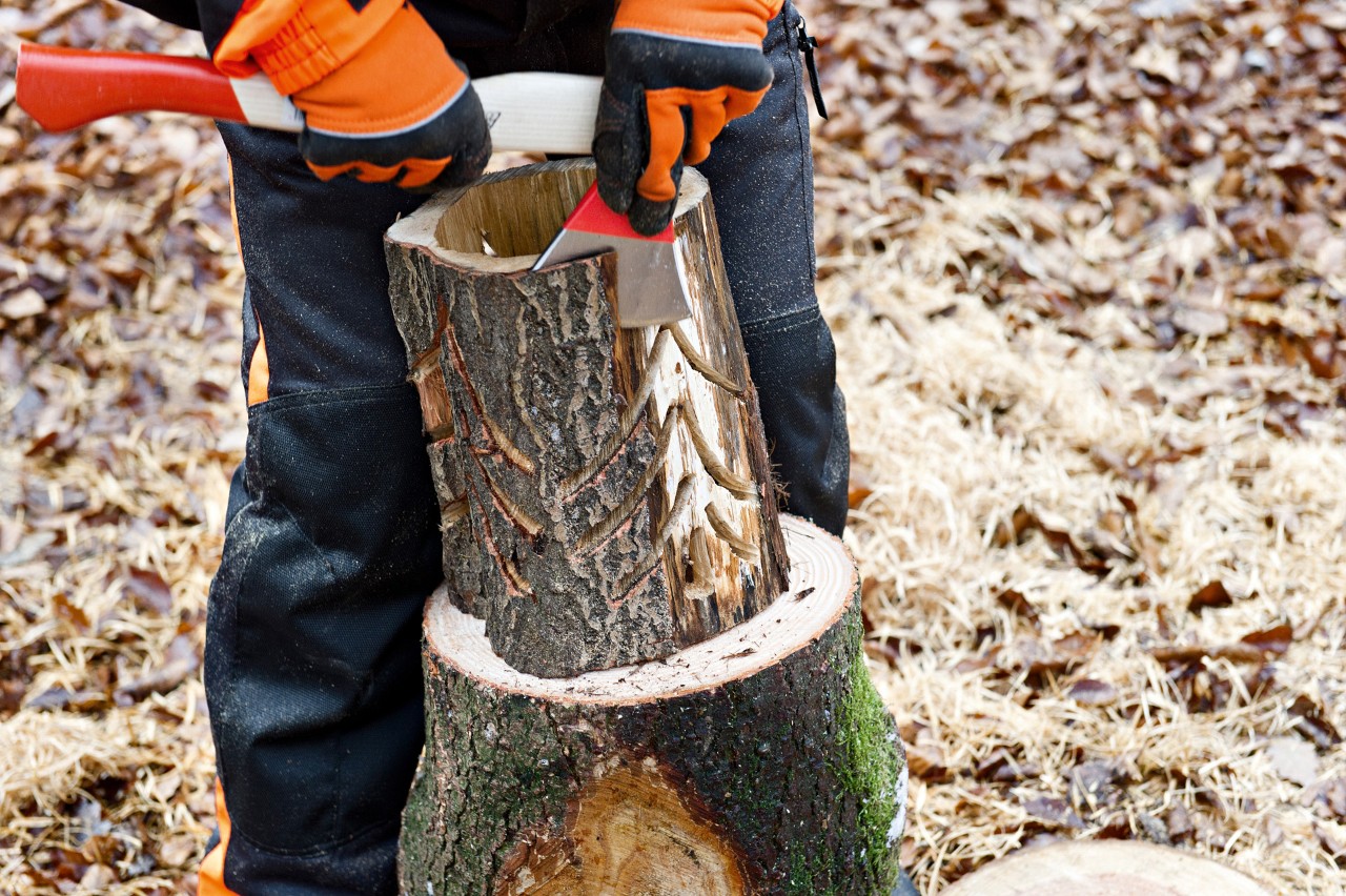 Bark being removed from a DIY log lantern with a STIHL AX 6 forestry hatchet
