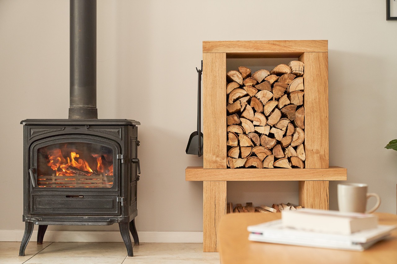 Fireplace and a DIY firewood rack filled with logs in an indoor space