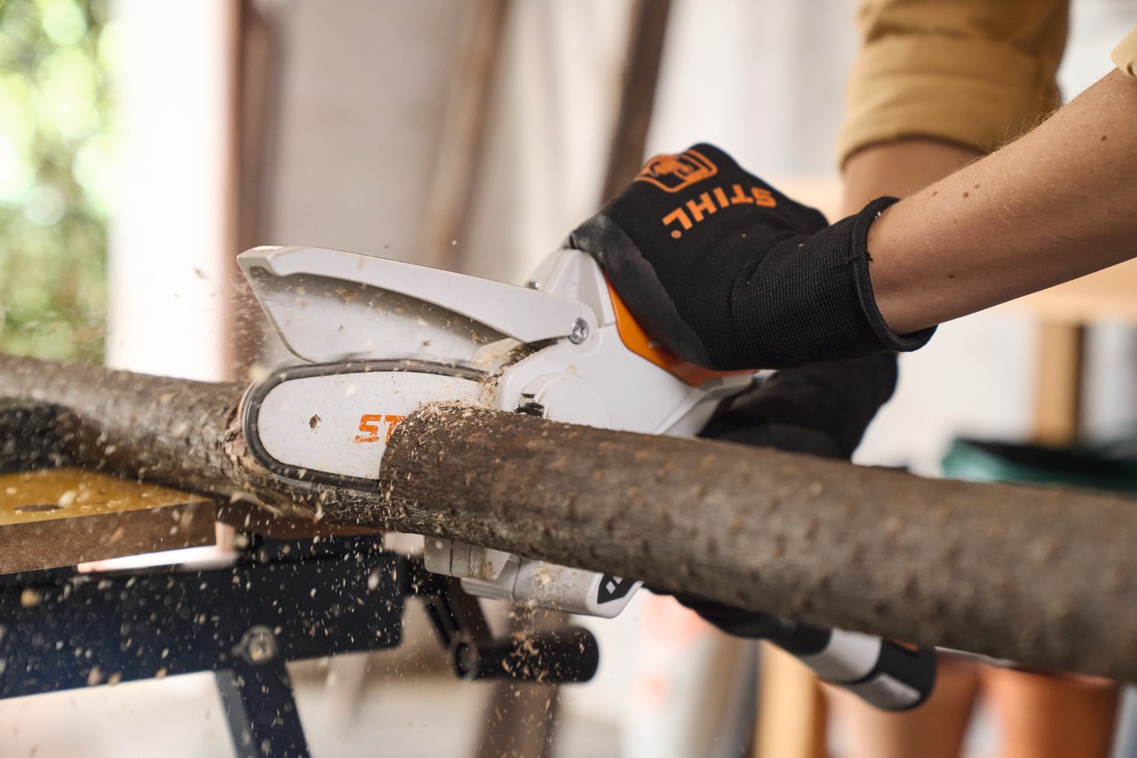 Close-up of someone cutting a branch to length with STIHL GTA 26 garden pruners