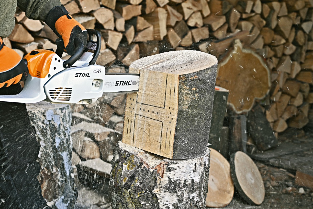 Making a bug hotel: recesses for a bug hotel being cut with a STIHL MS 151 C electric chainsaw