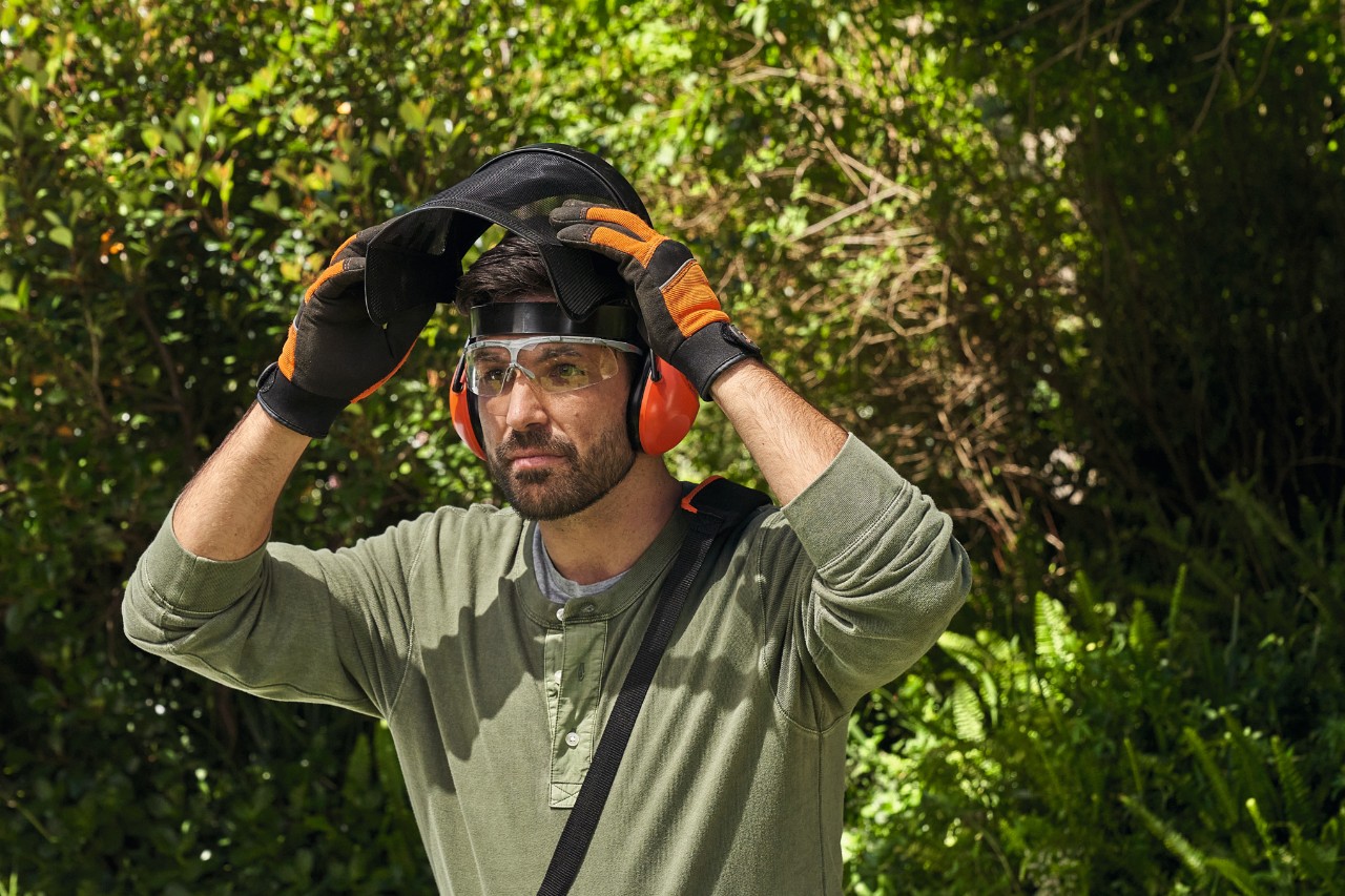 A man wearing STIHL personal protective equipment in a garden 