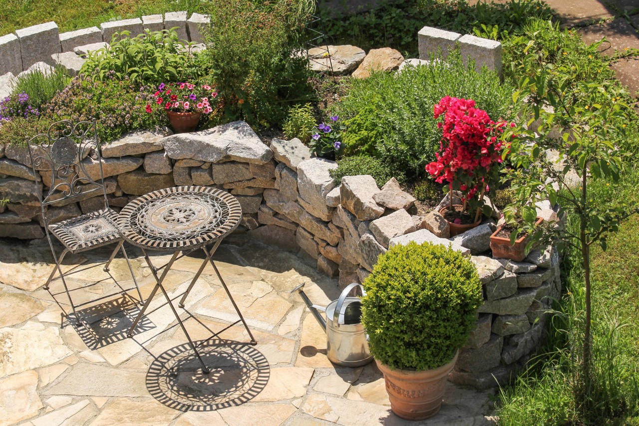Mediterranean hillside garden with terrace and garden furniture