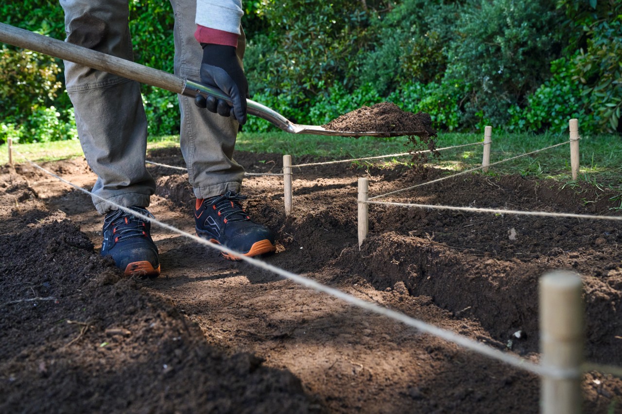 A man digs out the main path with a spade