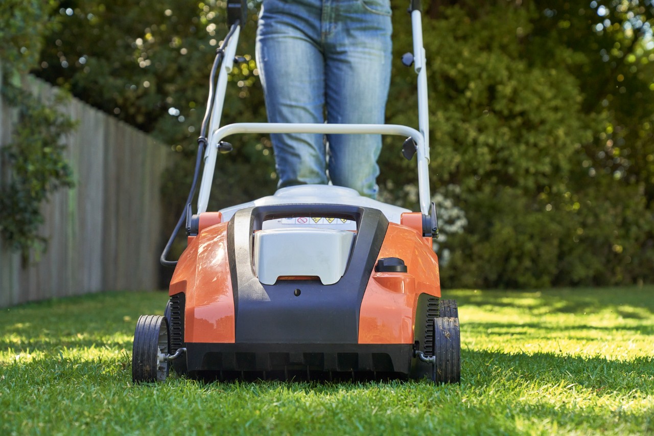 Close-up: aerating lawn with STIHL RLA 240 cordless lawn scarifier.