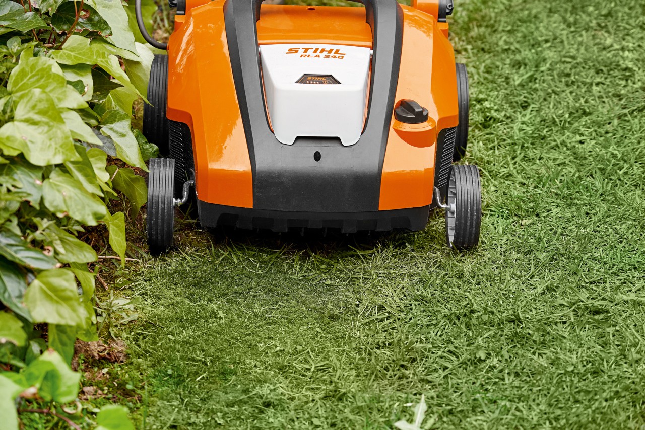 Close-up of a STIHL RLA 240 cordless lawn aerator before sanding a lawn