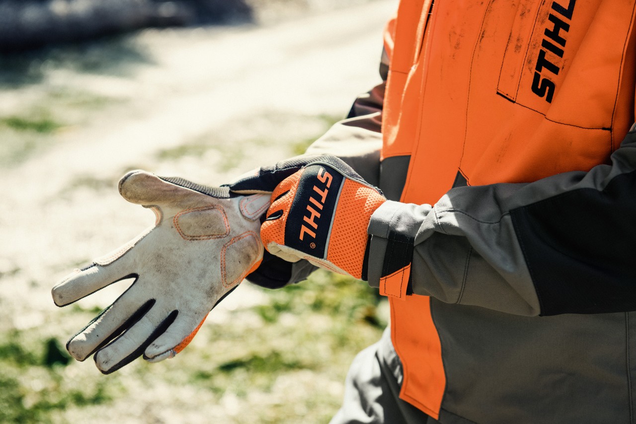 A close-up of STIHL ADVANCE Ergo MS protective gloves being put on
